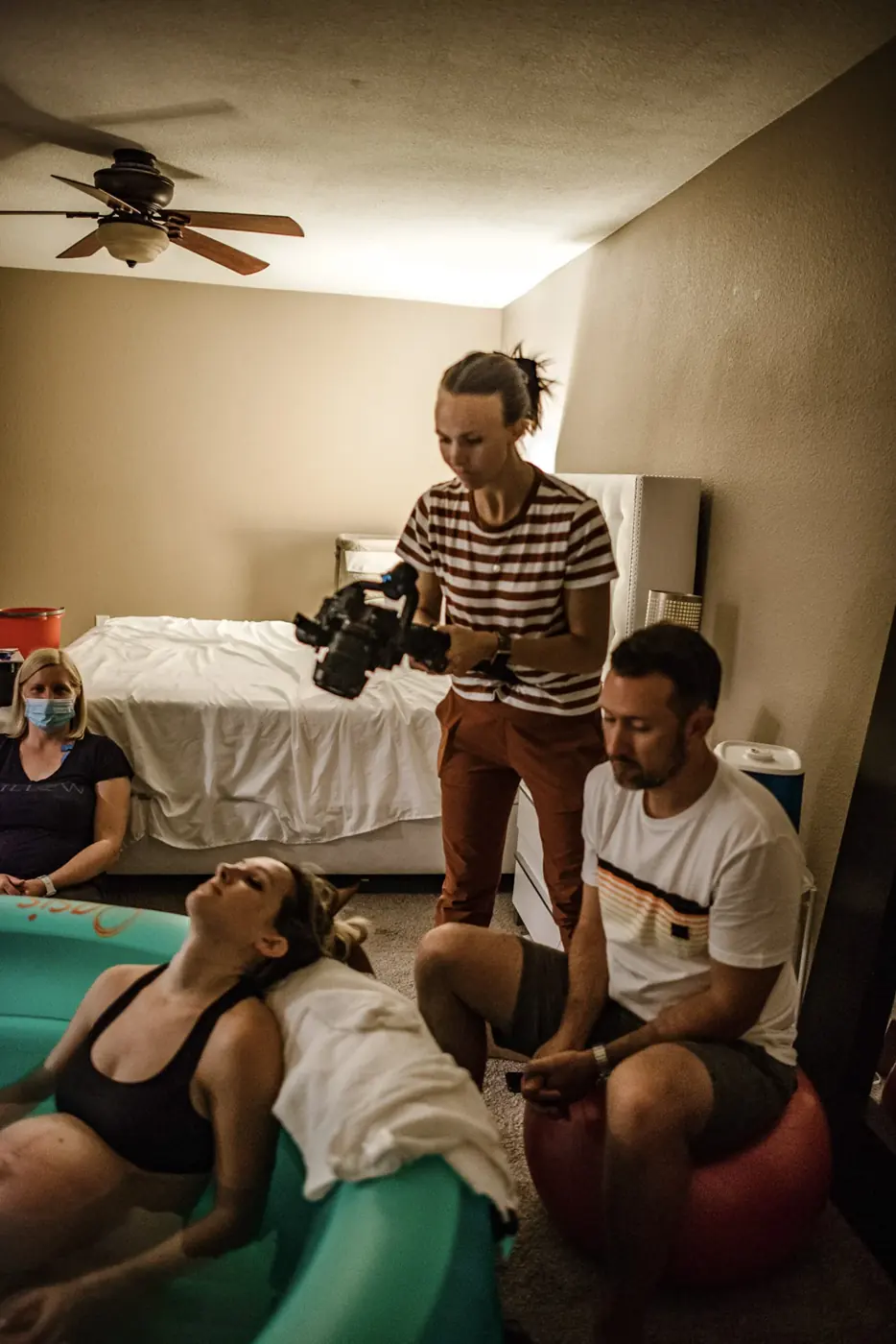 Susan filming with her camera and gimbal during a birth-documentary session.