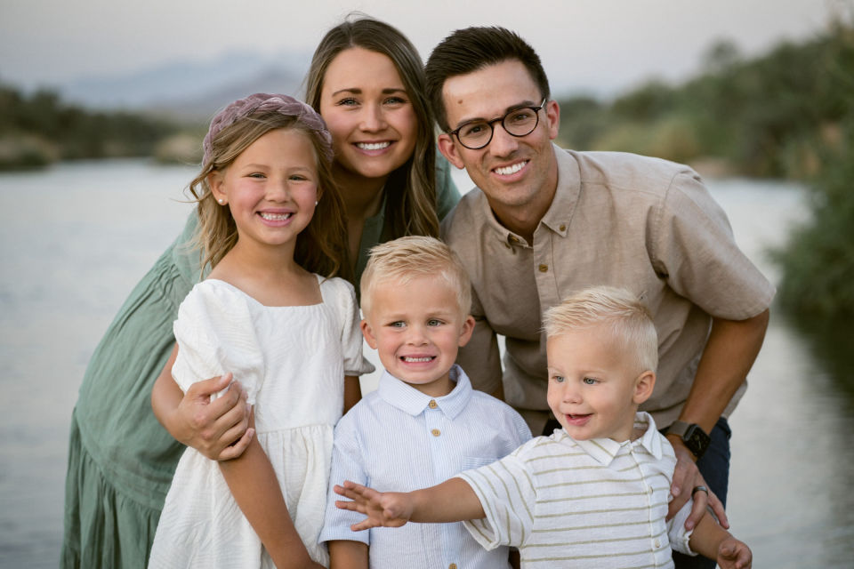 Close family portrait beside the water.