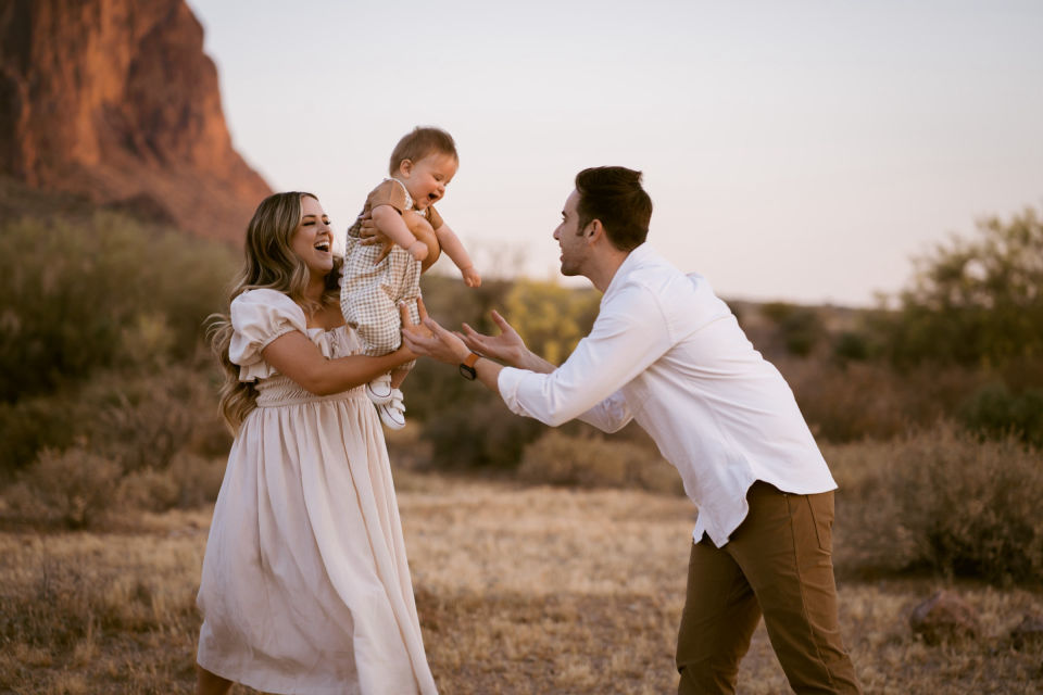 Parents playing with their child during a desert family session.
