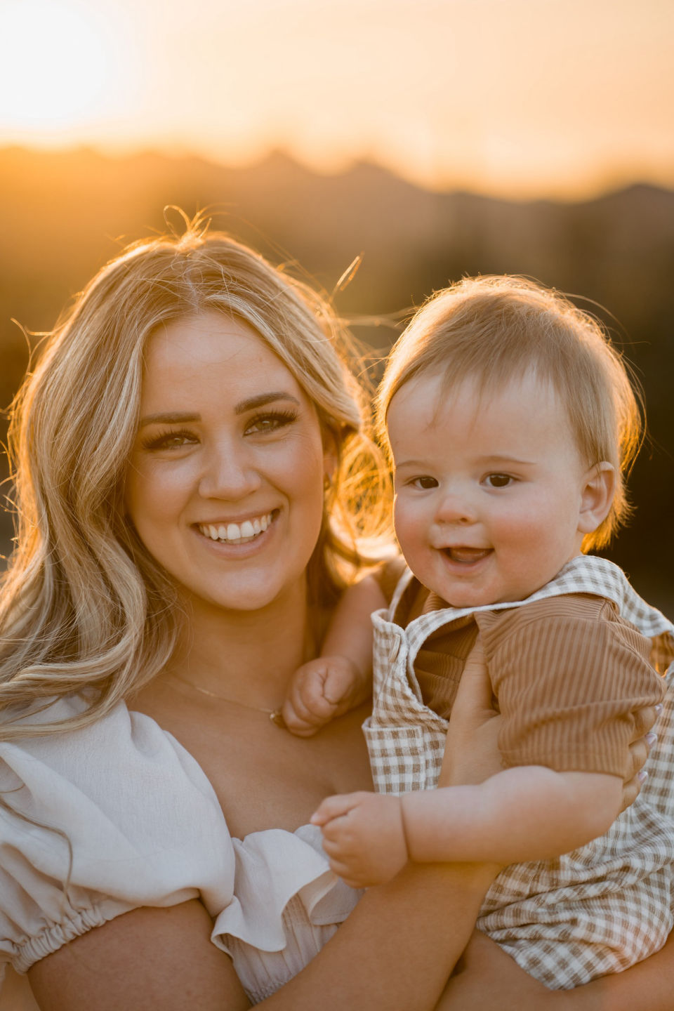 Mother and child smiling in warm evening light.