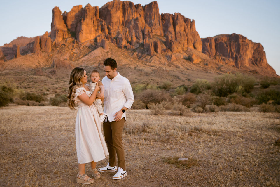 Wilson family together beneath warm desert mountains.